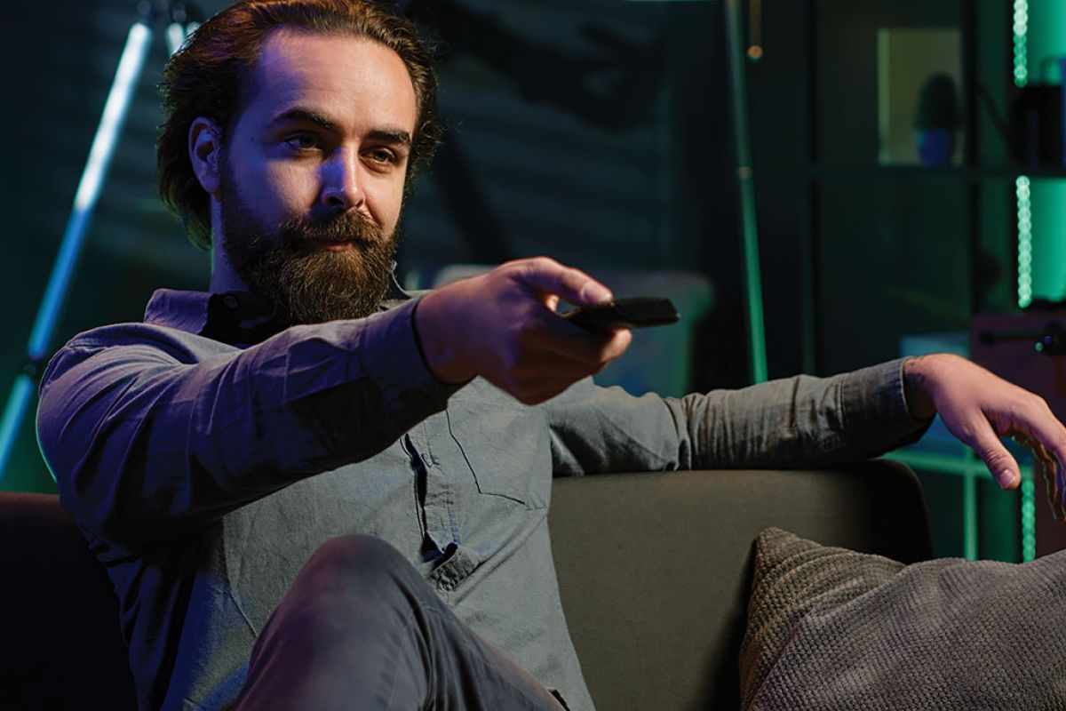 person arriving apartment sitting down couch enjoy movies 3e66678f